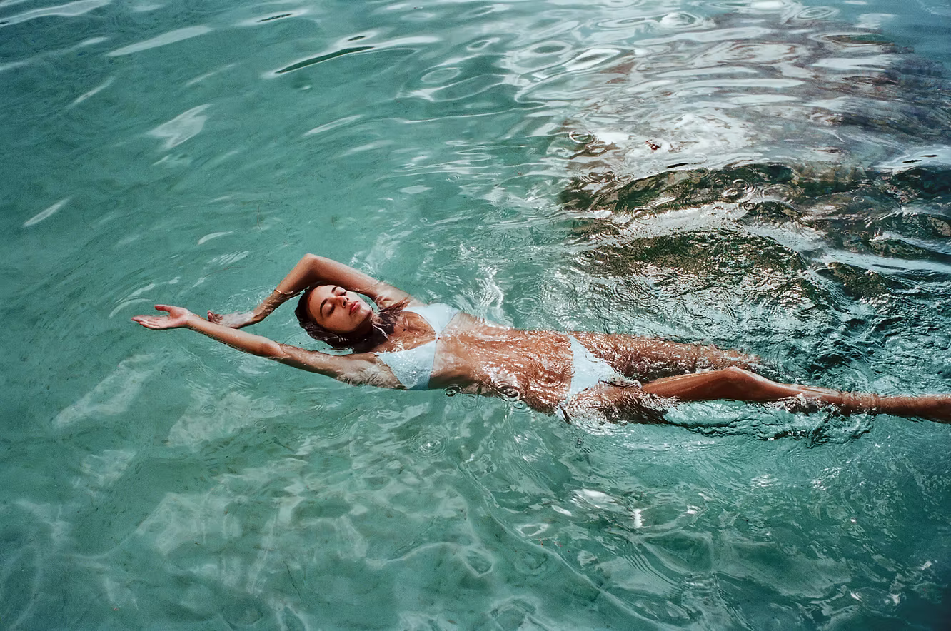woman swimming in clear blue water